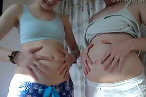 Two Girls Rub Their Tummy